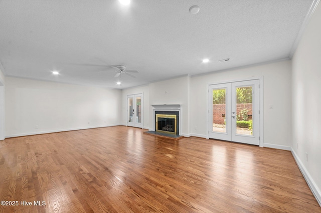 809 Greenbriar Rd, Kinston, NC 28501 - unfurnished living room with french doors, a ceiling fan, wood finished floors, recessed lighting, and a glass covered fireplace