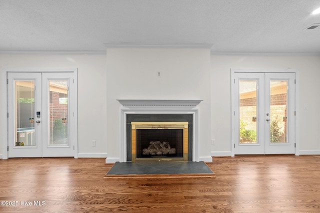 809 Greenbriar Rd, Kinston, NC 28501 - unfurnished living room featuring french doors, crown molding, wood finished floors, and a textured ceiling