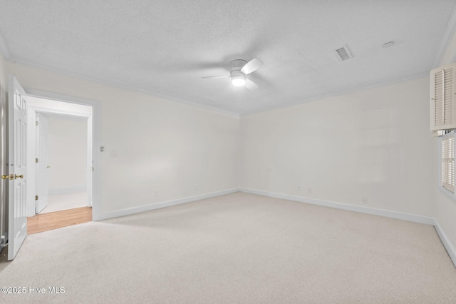809 Greenbriar Rd, Kinston, NC 28501 - spare room with light carpet, ceiling fan, ornamental molding, baseboards, and a textured ceiling