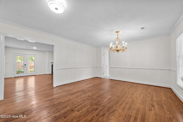 809 Greenbriar Rd, Kinston, NC 28501 - unfurnished room with a textured ceiling, wood finished floors, crown molding, a chandelier, and baseboards