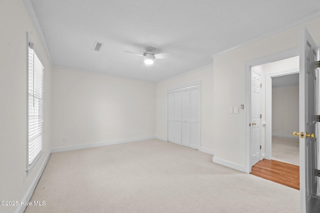 809 Greenbriar Rd, Kinston, NC 28501 - unfurnished bedroom featuring light colored carpet, crown molding, baseboards, a closet, and a ceiling fan