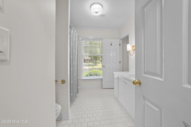 809 Greenbriar Rd, Kinston, NC 28501 - bathroom with vanity, toilet, baseboards, tile patterned floors, and ornamental molding