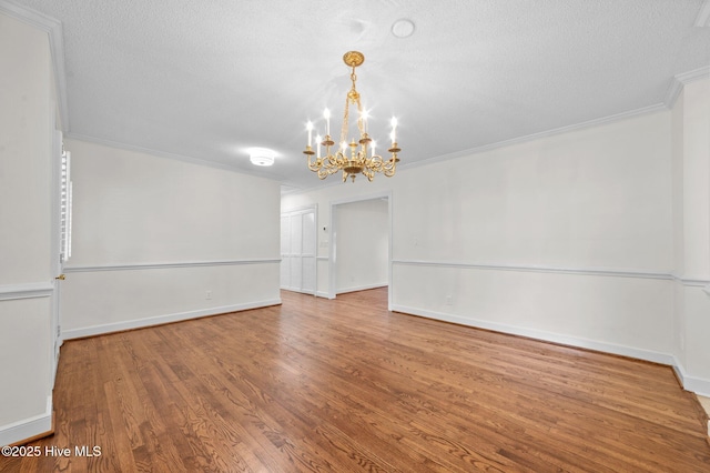 809 Greenbriar Rd, Kinston, NC 28501 - unfurnished room featuring a chandelier, wood finished floors, a textured ceiling, ornamental molding, and baseboards