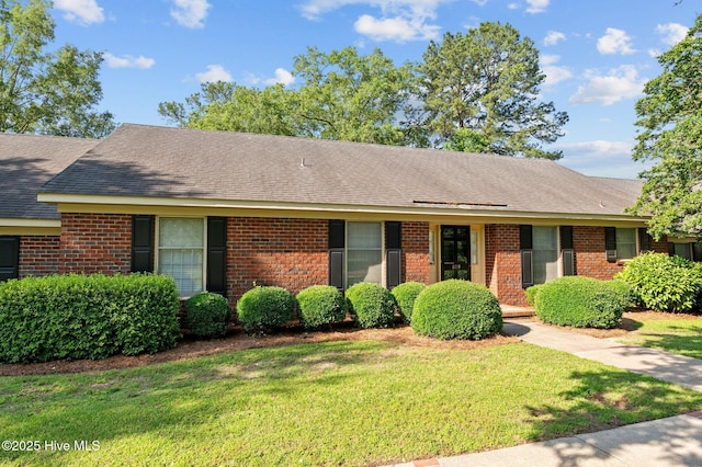 809 Greenbriar Rd, Kinston, NC 28501 - ranch-style home with brick siding, a front yard, and a shingled roof