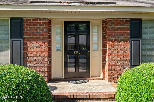 809 Greenbriar Rd, Kinston, NC 28501 - view of exterior entry with brick siding and roof with shingles