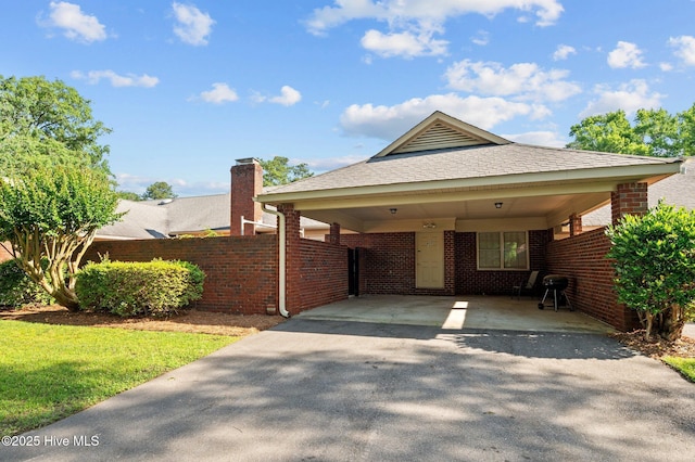 809 Greenbriar Rd, Kinston, NC 28501 - view of front of property featuring asphalt driveway, brick siding, a chimney, a carport, and roof with shingles