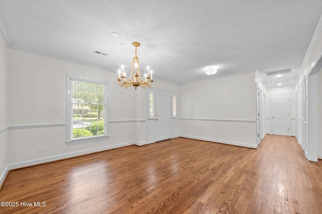 809 Greenbriar Rd, Kinston, NC 28501 - unfurnished room with light wood finished floors, a textured ceiling, crown molding, a chandelier, and baseboards