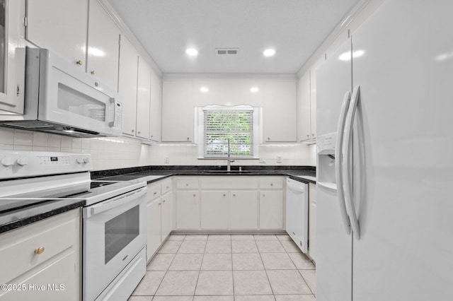 809 Greenbriar Rd, Kinston, NC 28501 - kitchen featuring white appliances, a sink, backsplash, light tile patterned floors, and white cabinets