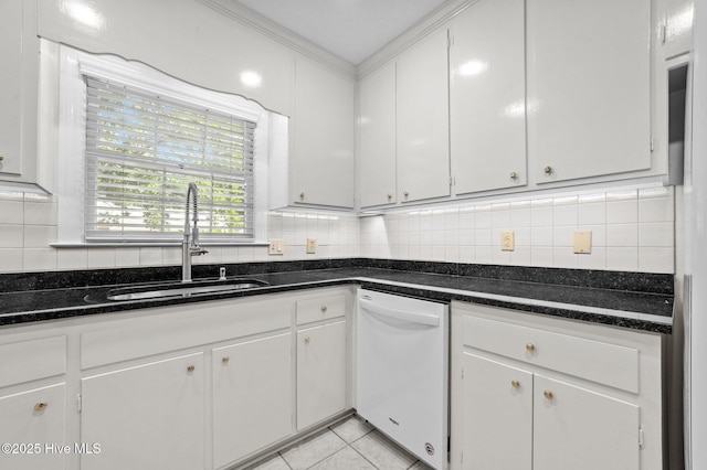809 Greenbriar Rd, Kinston, NC 28501 - kitchen featuring white dishwasher, a sink, decorative backsplash, white cabinets, and light tile patterned floors