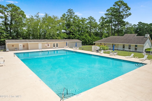 220 Boundary Loop Rd NW, Calabash, NC 28467 - community pool featuring a patio area and view of wooded area