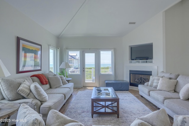 601 New River Inlet Rd, North Topsail Beach, NC 28460 - living room featuring wood finished floors, a fireplace, high vaulted ceiling, and baseboards