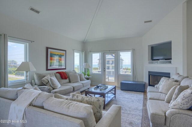 601 New River Inlet Rd, North Topsail Beach, NC 28460 - living room with healthy amount of natural light, wood finished floors, a fireplace, and high vaulted ceiling