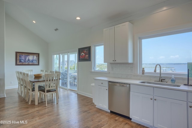 601 New River Inlet Rd, North Topsail Beach, NC 28460 - kitchen with dishwasher, a sink, light countertops, baseboards, and recessed lighting