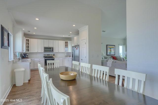 601 New River Inlet Rd, North Topsail Beach, NC 28460 - dining room featuring crown molding, recessed lighting, wood finished floors, and baseboards