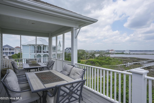 601 New River Inlet Rd, North Topsail Beach, NC 28460 - wooden terrace featuring a water view and outdoor dining space