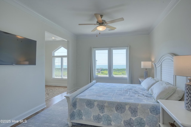 601 New River Inlet Rd, North Topsail Beach, NC 28460 - bedroom with crown molding, baseboards, wood finished floors, and a ceiling fan