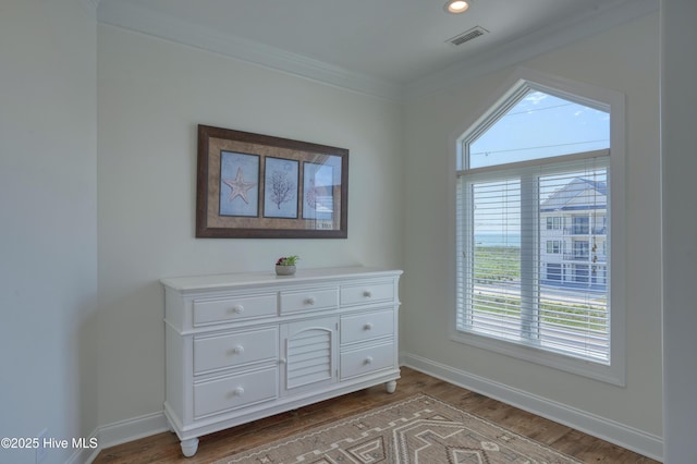 601 New River Inlet Rd, North Topsail Beach, NC 28460 - detailed view of wood finished floors, baseboards, crown molding, and recessed lighting