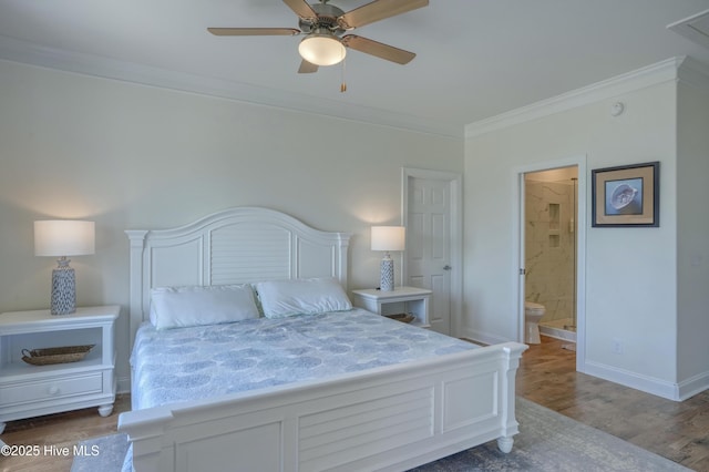 601 New River Inlet Rd, North Topsail Beach, NC 28460 - bedroom with crown molding, ensuite bathroom, wood finished floors, baseboards, and ceiling fan