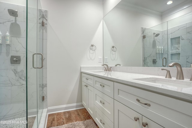 601 New River Inlet Rd, North Topsail Beach, NC 28460 - full bathroom featuring crown molding, a marble finish shower, double vanity, baseboards, and wood finished floors