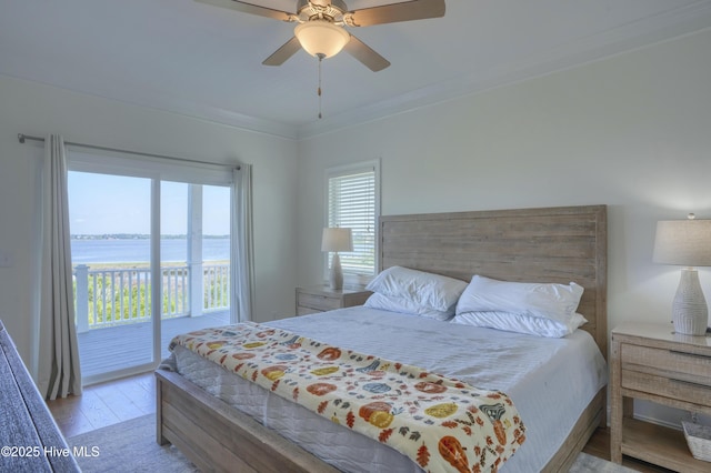 601 New River Inlet Rd, North Topsail Beach, NC 28460 - bedroom with access to exterior, multiple windows, wood finished floors, a water view, and crown molding