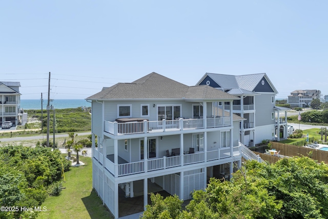 601 New River Inlet Rd, North Topsail Beach, NC 28460 - back of house featuring a balcony, a shingled roof, a yard, and a water view