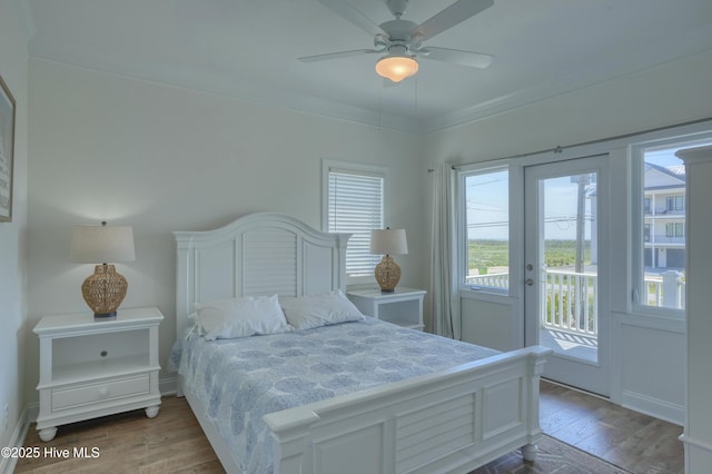 601 New River Inlet Rd, North Topsail Beach, NC 28460 - bedroom with access to outside, multiple windows, wood finished floors, ornamental molding, and ceiling fan
