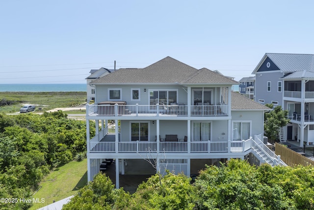 601 New River Inlet Rd, North Topsail Beach, NC 28460 - back of property with a shingled roof, a balcony, and stairs