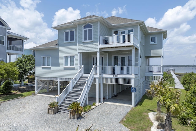 601 New River Inlet Rd, North Topsail Beach, NC 28460 - beach home featuring a carport, driveway, roof with shingles, and a balcony