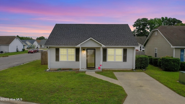 102 Oakwood Ln, Elizabeth City, NC 27909 - bungalow-style house with a yard and a shingled roof