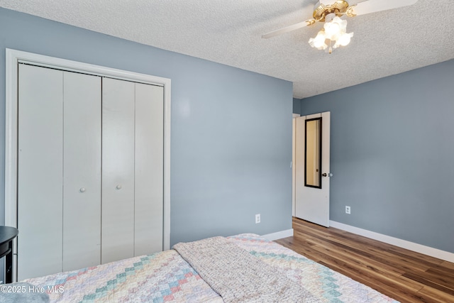 102 Oakwood Ln, Elizabeth City, NC 27909 - bedroom featuring wood finished floors, baseboards, a textured ceiling, a closet, and ceiling fan