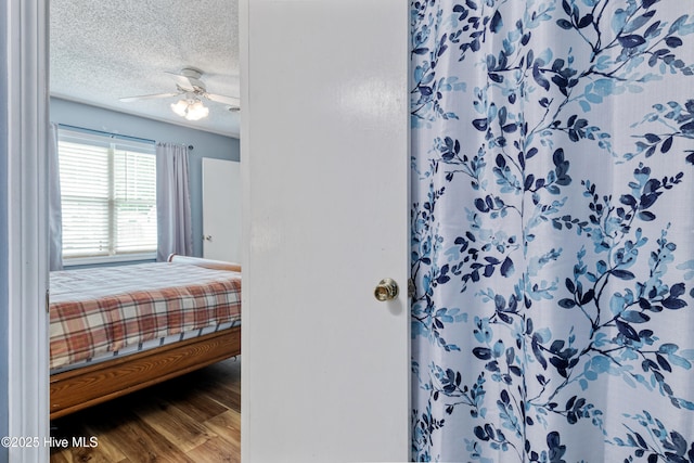 102 Oakwood Ln, Elizabeth City, NC 27909 - bedroom featuring wood finished floors, a textured ceiling, and a ceiling fan