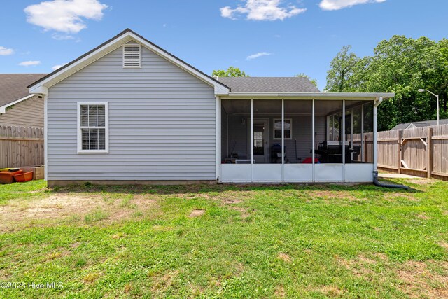 102 Oakwood Ln, Elizabeth City, NC 27909 - rear view of house with a sunroom and roof with shingles