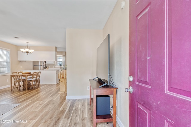 102 Oakwood Ln, Elizabeth City, NC 27909 - entryway with a chandelier, light wood finished floors, and baseboards