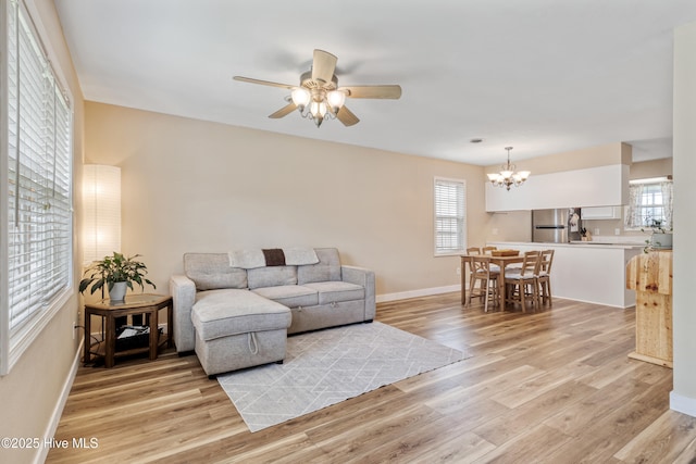 102 Oakwood Ln, Elizabeth City, NC 27909 - living room featuring healthy amount of natural light, light wood-type flooring, a chandelier, and a ceiling fan