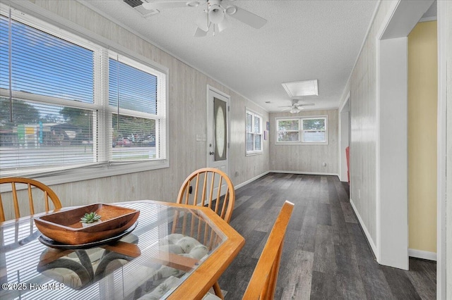 3331 Holden Beach Rd SW, Supply, NC 28462 - dining area featuring ceiling fan, dark wood-style flooring, baseboards, a textured ceiling, and ornamental molding