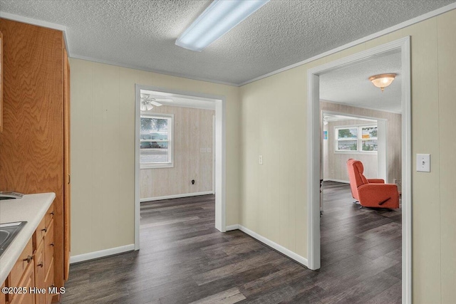 3331 Holden Beach Rd SW, Supply, NC 28462 - hallway featuring dark wood finished floors, a textured ceiling, and baseboards