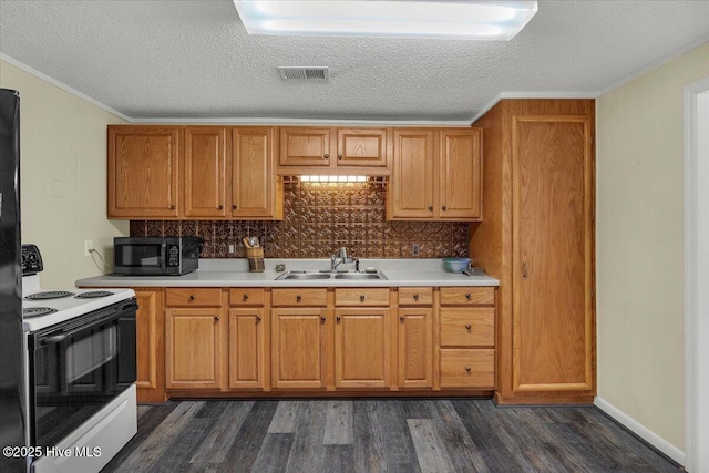 3331 Holden Beach Rd SW, Supply, NC 28462 - kitchen featuring range with electric cooktop, a sink, dark wood-style flooring, light countertops, and a textured ceiling