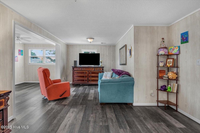 3331 Holden Beach Rd SW, Supply, NC 28462 - living room featuring wood finished floors, a textured ceiling, baseboards, a ceiling fan, and crown molding