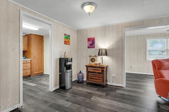 3331 Holden Beach Rd SW, Supply, NC 28462 - sitting room featuring dark wood-type flooring, a textured ceiling, baseboards, and ornamental molding