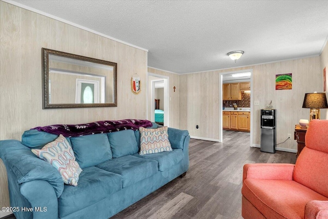 3331 Holden Beach Rd SW, Supply, NC 28462 - living area featuring dark wood finished floors, ornamental molding, a textured ceiling, and baseboards