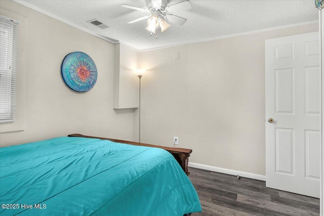 3331 Holden Beach Rd SW, Supply, NC 28462 - bedroom featuring wood finished floors, a textured ceiling, crown molding, a ceiling fan, and baseboards