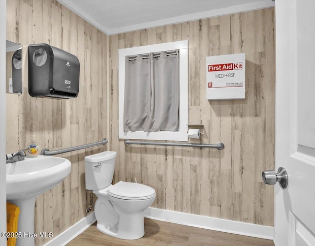 3331 Holden Beach Rd SW, Supply, NC 28462 - bathroom with toilet, wooden walls, wood finished floors, and a sink