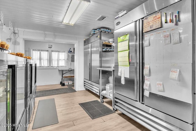 3331 Holden Beach Rd SW, Supply, NC 28462 - kitchen with light wood-type flooring and stainless steel fridge