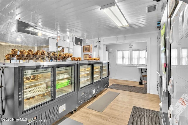 3331 Holden Beach Rd SW, Supply, NC 28462 - bar featuring freestanding refrigerator, wood finished floors, and baseboards