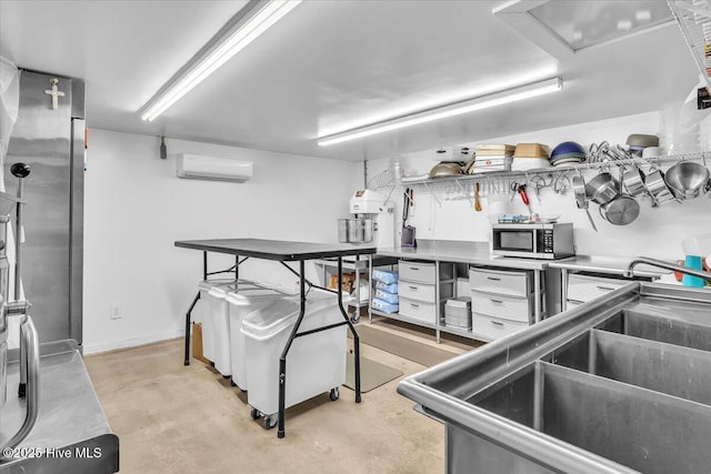 3331 Holden Beach Rd SW, Supply, NC 28462 - kitchen with a wall mounted AC, stainless steel microwave, concrete flooring, and a sink
