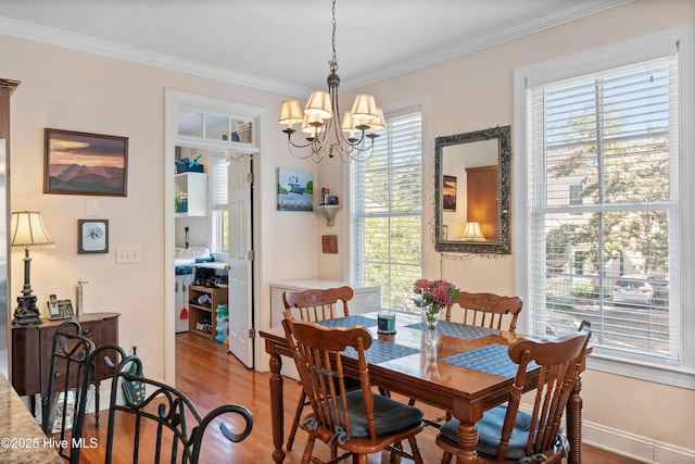 700 S 3rd St, Wilmington, NC 28401 - dining area featuring wood finished floors, crown molding, a chandelier, and baseboards