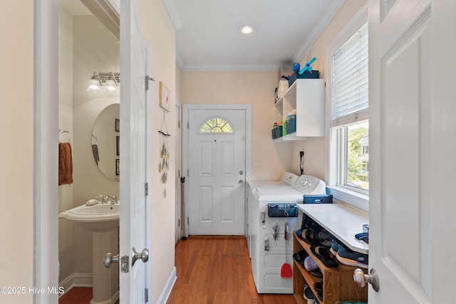 700 S 3rd St, Wilmington, NC 28401 - laundry room with washer and clothes dryer, light wood finished floors, and ornamental molding