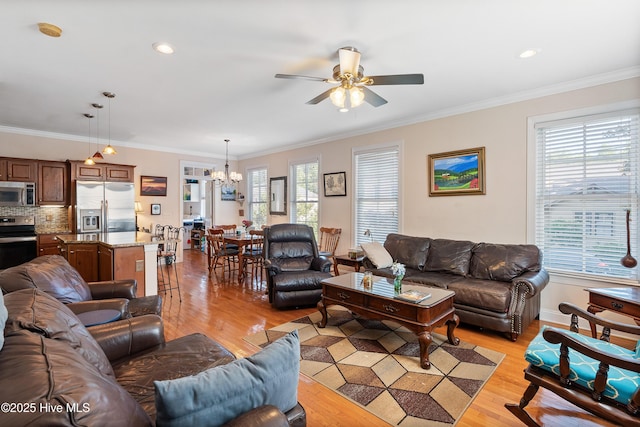 700 S 3rd St, Wilmington, NC 28401 - living room featuring light wood finished floors, a chandelier, a ceiling fan, plenty of natural light, and ornamental molding
