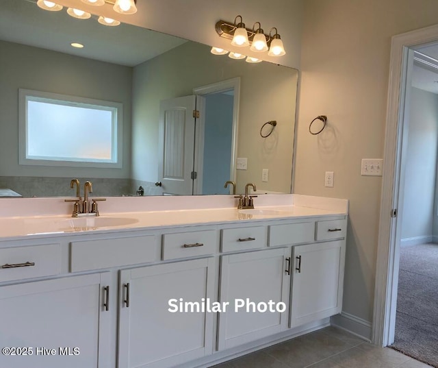 635 Indigo Johnston Dr, Jacksonville, NC 28546 - bathroom featuring double vanity, tile patterned flooring, and baseboards