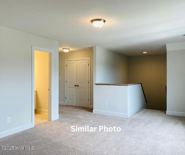 635 Indigo Johnston Dr, Jacksonville, NC 28546 - carpeted spare room with baseboards and a textured ceiling